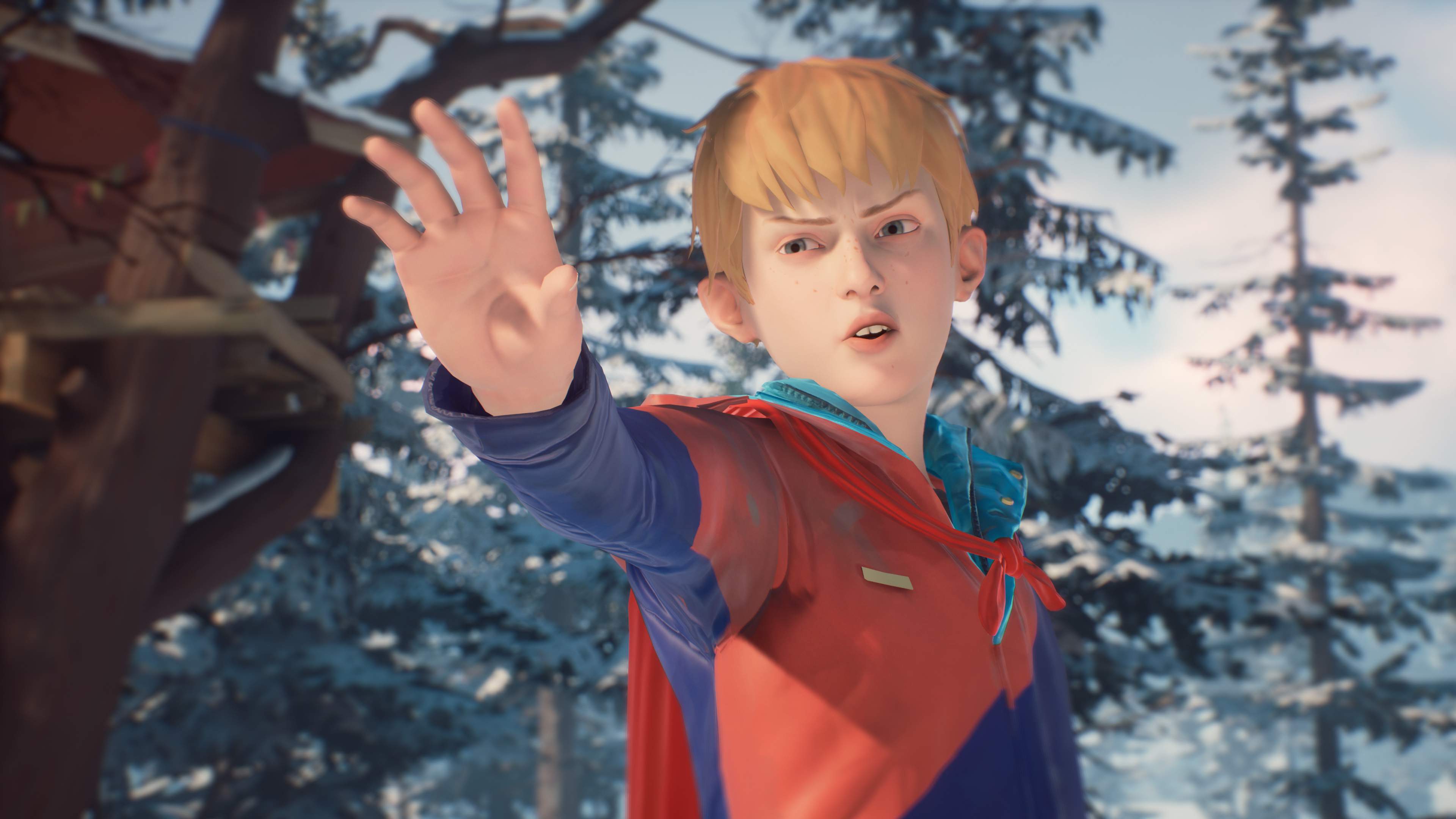 Chris, reaches out his hand in a power pose. He wears a red superhero cape. A snowcapped treehouse is visible behind him.