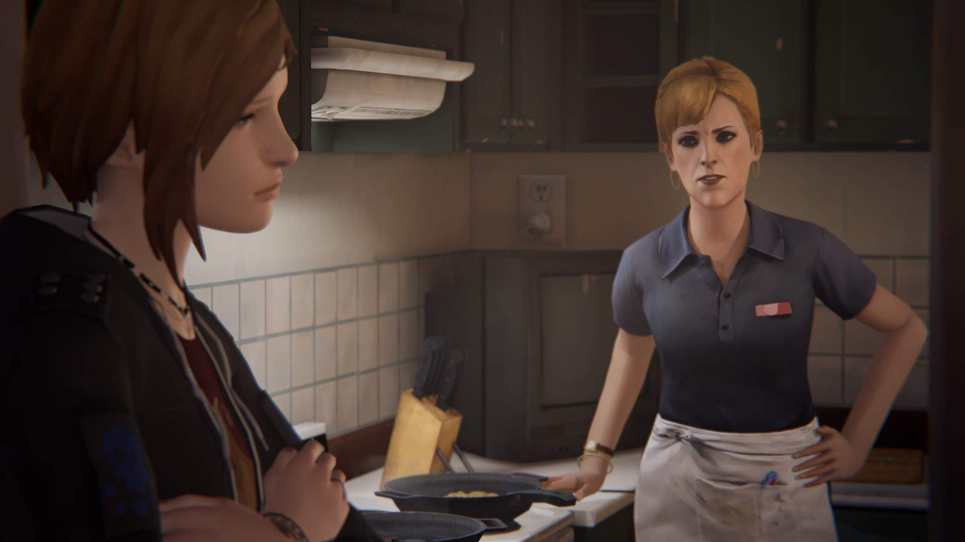 Chloe, arms folded, listens to a lecture from her mother, Joyce, in the kitchen of their home.