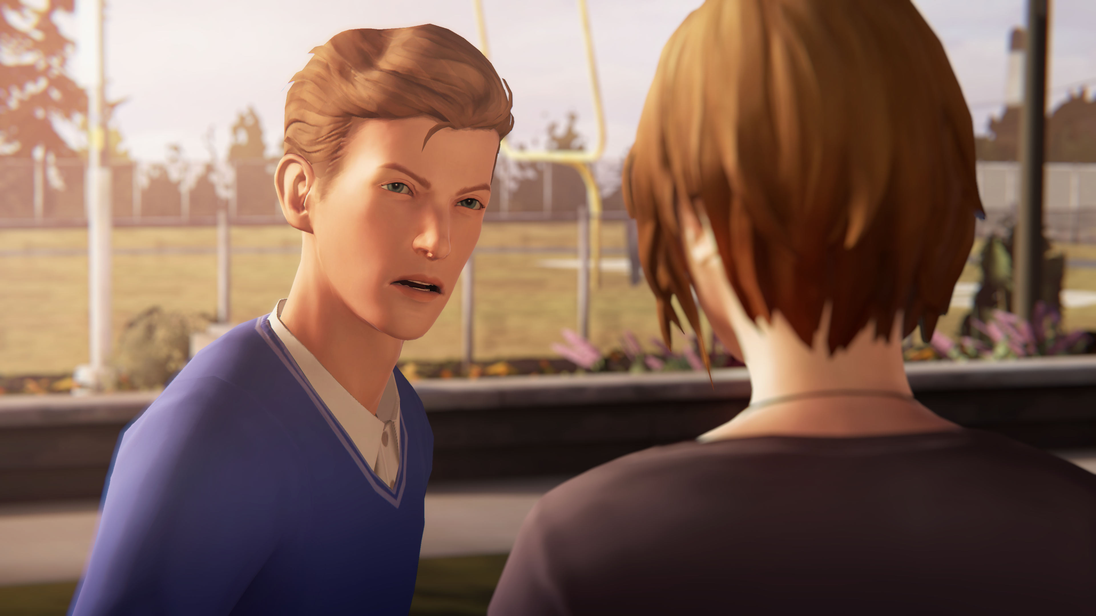 An angry Nathan Prescott, in a preppy blue sweater, confronts Chloe Price outside of Blackwell Academy.