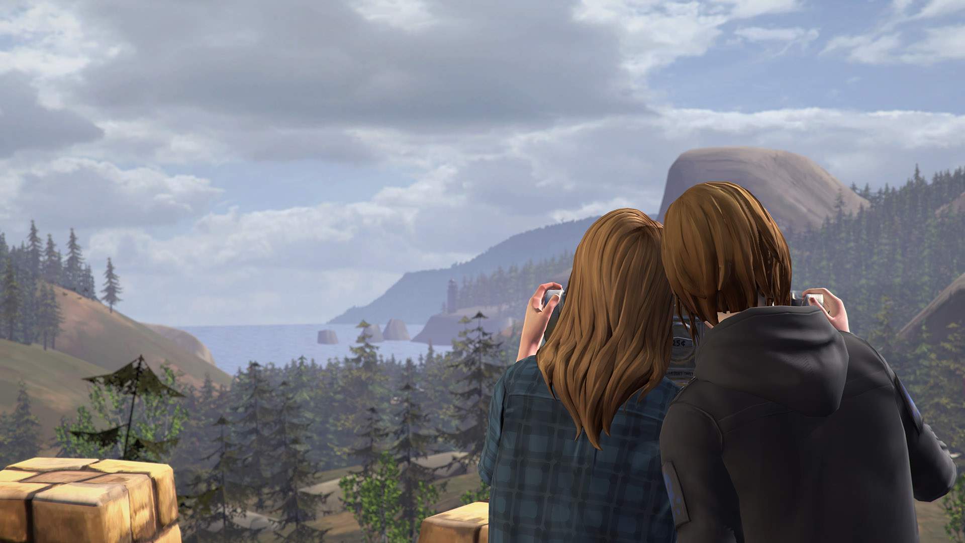 Rachel Amber and Chloe Price take in the stunning view of Overlook Park: trees, mountains, sea, and glorious sky.