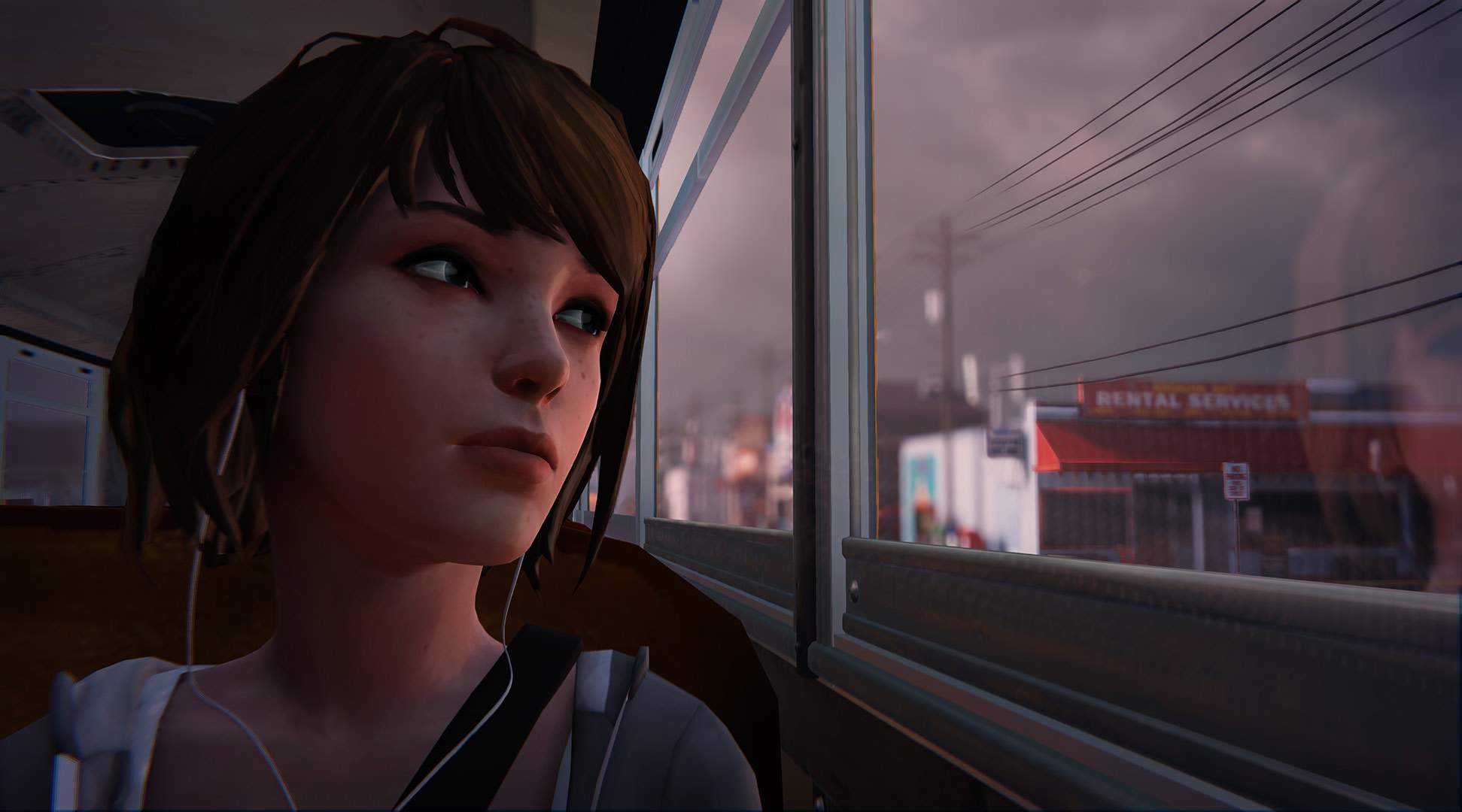 Her headphones in, Max rides the bus through Arcadia Bay, gazing out of the window at the gathering stormclouds.