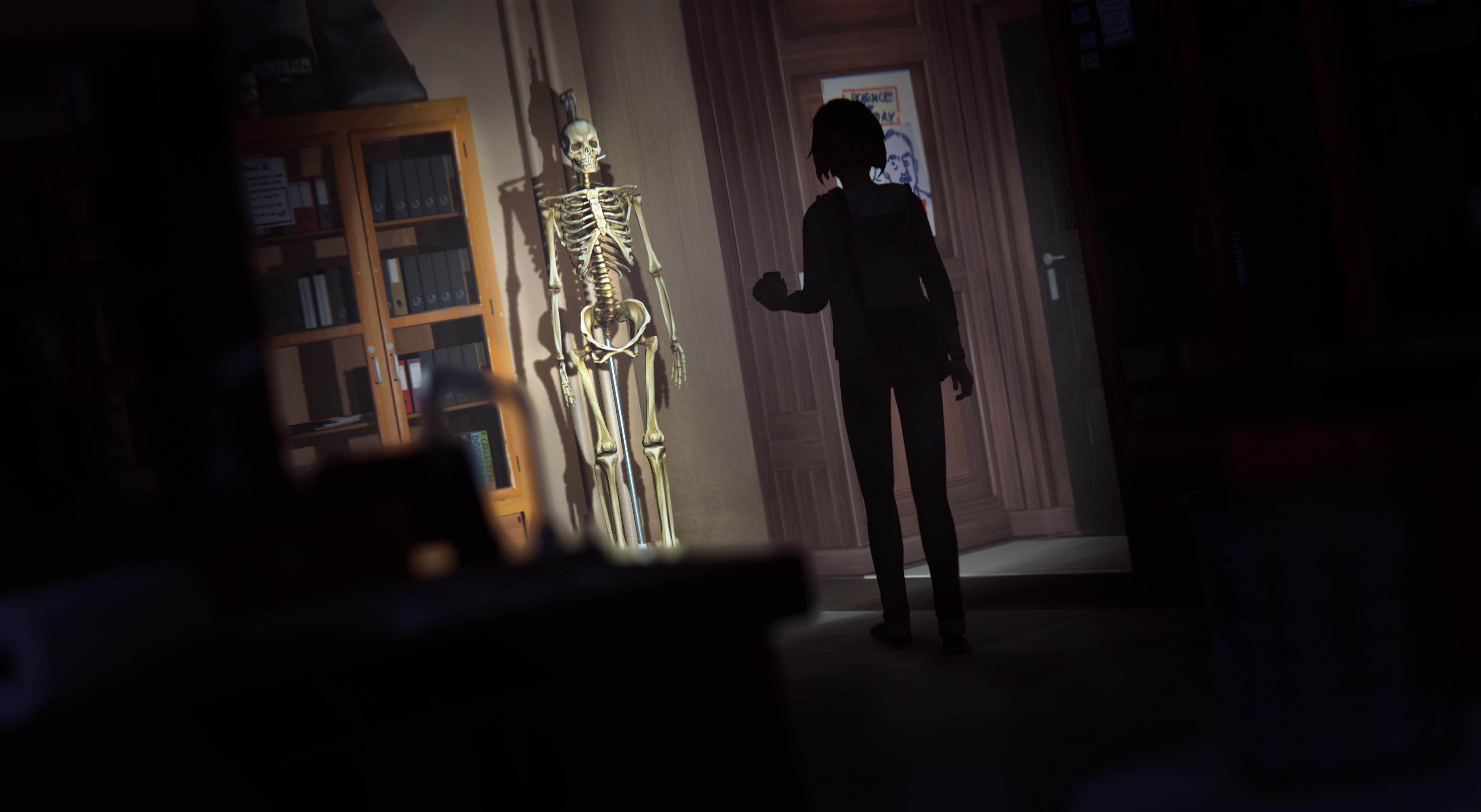 In a dark Blackwell Academy science classroom, Max's phone flashlight illuminates an anatomical skeleton.