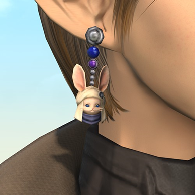 A close-up of an earring in the shape of the head of a Loporrit, a small-rabbit like creature wearing a cloth hat. The earring is also beset with round purple and blue jewels.