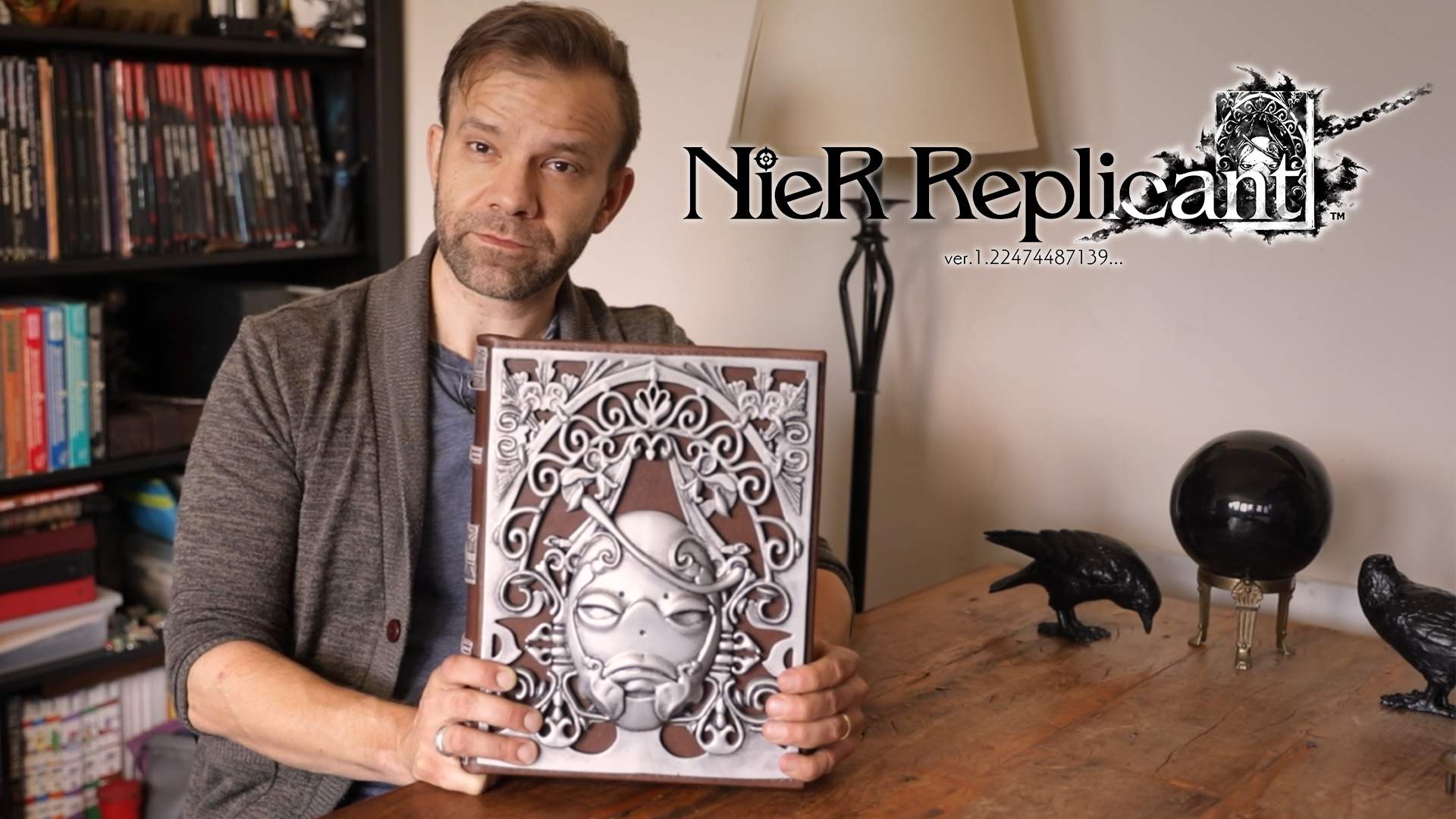 Liam O’Brien holding ancient book replica, NieR Replicant